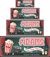  Personalized home theater sign with retro neon lettering, featuring illustrations of dancing popcorn, a clapboard, and movie tickets. All lines of text are editable. Sign does not light up but gives the effect of neon lighting. Perfect for adding nostalgic charm to your home movie theater.