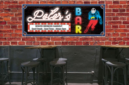 Personalized retro wall art featuring a football player, customizable with six sports balls (football, hockey, golf, soccer, baseball, or basketball) and editable text in retro neon-style lettering. Sign colors are coordinated with the team colors of your choice. Ideal for bars, man caves, or as a gift for sports fans.
