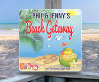 Personalized beach house sign featuring a tropical drink, seashells, flip flops, and seagulls, with editable text