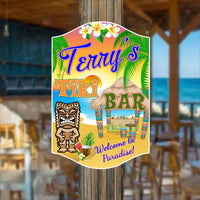 Personalized tiki bar welcome sign with editable text, featuring a desert island beach scene, colorful tiki bar, tiki totem, palm trees, and a sunset