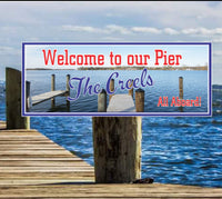  Personalized pier welcome sign for boat owners with a photographic lake background, blue skies, and wooden pier. Customizable text for a unique nautical touch. Perfect for docks and boathouses.